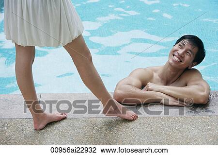 Man in pool looking up at woman View Large Photo Image Stock Image - Man in pool looking up at woman. Fotosearch
