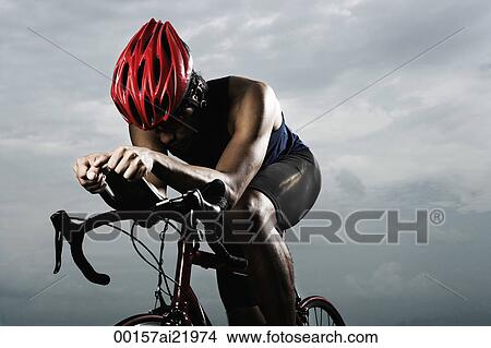 Man on bike, pedaling, racing, looking down View Large Photo Image Picture - Man on bike, pedaling, racing, looking down. Fotosearch