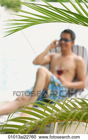 Man on deck chair talking on the phone View Large Photo Image Stock Image - Man on deck chair talking on the phone. Fotosearch