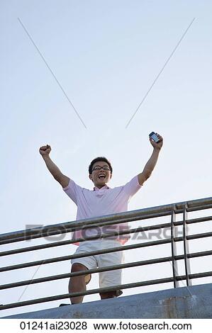 Man raising his arms in victory View Large Photo Image Stock Photo - Man raising his arms in victory. Fotosearch