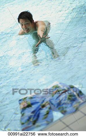 Stock Photograph - Man reaching for his lost shorts. Fotosearch