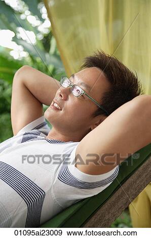 Man relaxing on deck chair View Large Photo Image Stock Photo - Man relaxing on deck chair. Fotosearch