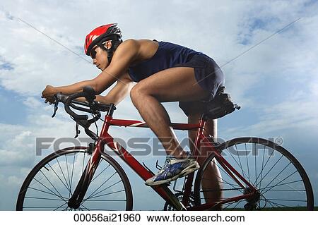 Stock Image - Man riding bike, racing. Fotosearch
