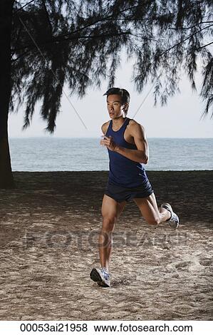Man running along beach, workout View Large Photo Image Stock Photo - Man running along beach, workout. Fotosearch