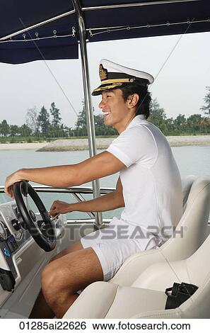 Man steering yacht View Large Photo Image Stock Photograph - Man steering yacht. Fotosearch