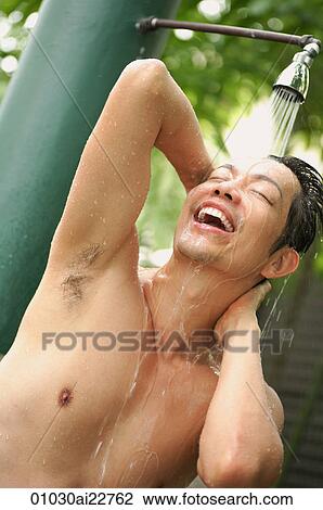 Stock Image - Man taking a shower outdoors. Fotosearch