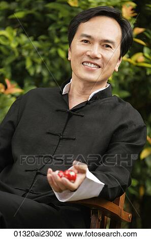 Stock Image - Man with meditation balls. Fotosearch