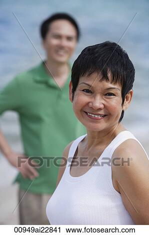 Mature couple at the beach, smiling at camera View Large Photo Image Stock Image - Mature couple at the beach, smiling at camera. Fotosearch