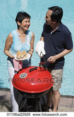 Mature couple having a barbeque View Large Photo Image Stock Photograph - Mature couple having a barbeque. Fotosearch