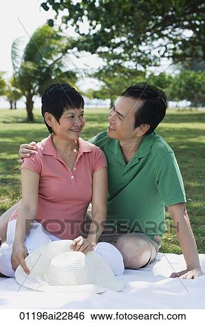 Mature couple having a picnic in the park View Large Photo Image Stock Photograph - Mature couple having a picnic in the park. Fotosearch