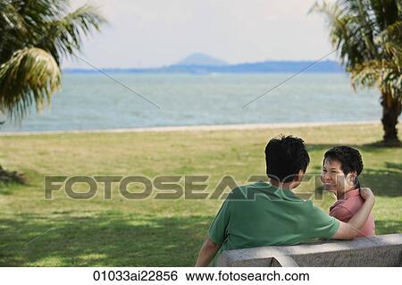 Stock Photograph - Mature couple in a park near the beach. Fotosearch