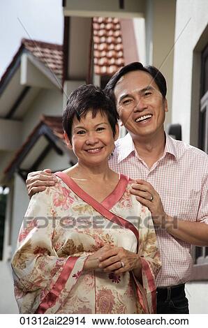 Mature couple smiling at camera View Large Photo Image Picture - Mature couple smiling at camera. Fotosearch