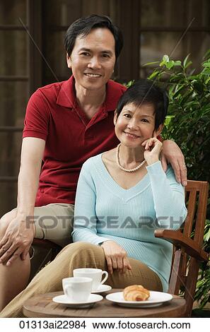 Mature couple smiling at camera View Large Photo Image Picture - Mature couple smiling at camera. Fotosearch