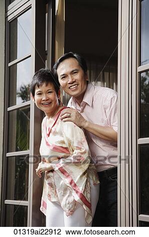 Mature couple smiling at camera View Large Photo Image Stock Image - Mature couple smiling at camera. Fotosearch