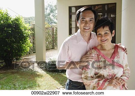 Stock Photo - Mature couple smiling at camera. Fotosearch