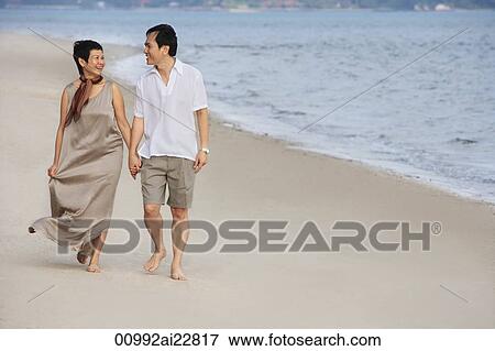 Mature couple walking at the beach View Large Photo Image Stock Photo - Mature couple walking at the beach. Fotosearch