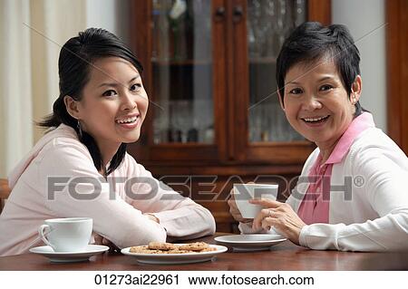 Mother and daughter enjoying tea together View Large Photo Image Stock Image - Mother and daughter enjoying tea together. Fotosearch