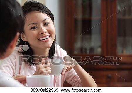 Stock Photo - Mother and daughter enjoying tea together. Fotosearch