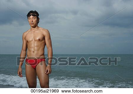 Muscled man wearing swim trunks by ocean, swimming View Large Photo Image Stock Photo - Muscled man wearing swim trunks by ocean, swimming. Fotosearch