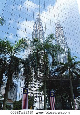 Stock Image - Petronas Towers reflected on the curtain wall of a commercial building, Kuala Lumpur, Malaysia. Fotosearch