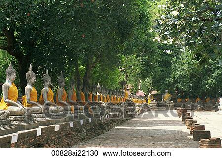 Stock Image - Rows of Buddhas in the courtyard at Wat Yai Chai Mongkhon, Ayutthara, Thailand. Fotosearch