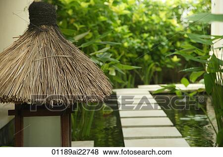 Stone path on a pond and lamp on Bali, Indonesia View Large Photo Image Stock Photo - Stone path on a pond and lamp on Bali, Indonesia. Fotosearch
