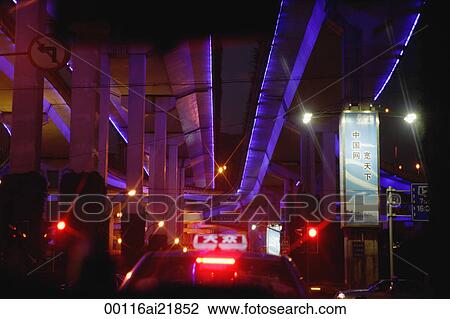 Stock Image - Taxi on freeway in Shanghai, China, focus on the Taxi Sign. Fotosearch