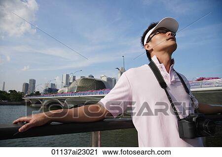 Stock Image - Tourist relaxing at the waterfront. Fotosearch