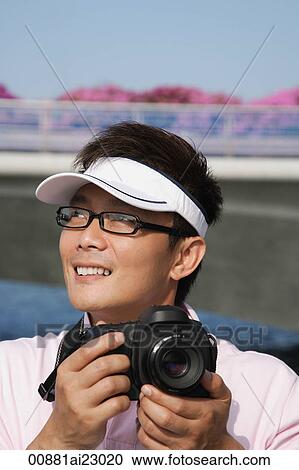 Stock Image - Tourist taking a photograph. Fotosearch