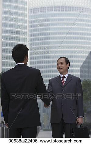 Two businessmen shake hands View Large Photo Image Stock Photograph - Two businessmen shake hands. Fotosearch