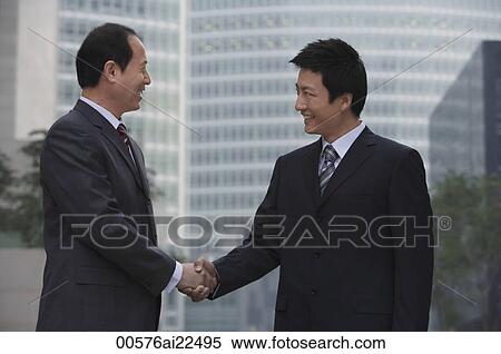 Two businessmen shake hands View Large Photo Image Stock Photography - Two businessmen shake hands. Fotosearch