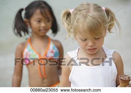 Two young girls at the beach View Large Photo Image Stock Photography - Two young girls at the beach. Fotosearch