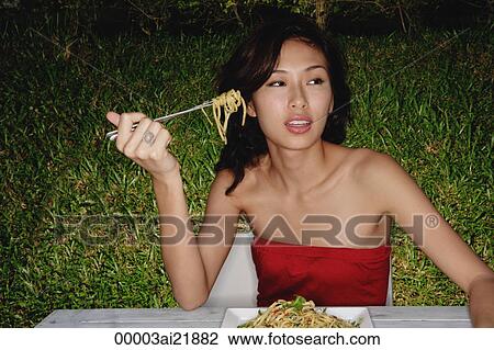 Woman in restaurant eating plate full of pasta View Large Photo Image Stock Image - Woman in restaurant eating plate full of pasta. Fotosearch