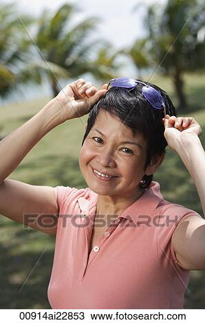 Woman in the park smiling at camera View Large Photo Image Stock Image - Woman in the park smiling at camera. Fotosearch