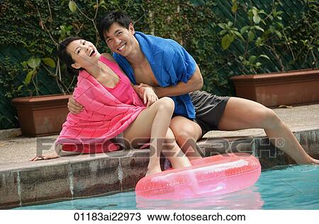 Young couple having fun at the pool View Large Photo Image Stock Image - Young couple having fun at the pool. Fotosearch