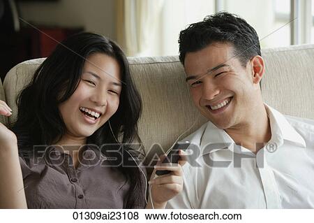 Stock Photo - Young couple laughing together. Fotosearch