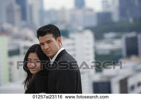 Young couple looking at camera View Large Photo Image Stock Photograph - Young couple looking at camera. Fotosearch