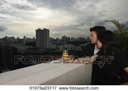 Stock Photo - Young couple looking into distance. Fotosearch