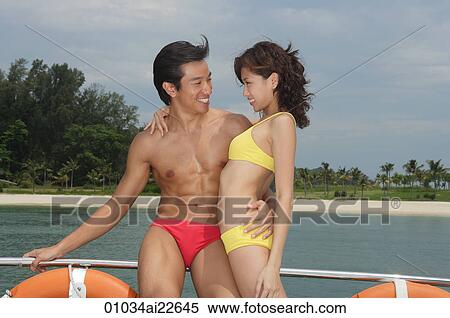 Young couple on yacht, looking at each other View Large Photo Image Stock Photography - Young couple on yacht, looking at each other. Fotosearch