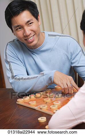 Young couple playing board game View Large Photo Image Picture - Young couple playing board game. Fotosearch