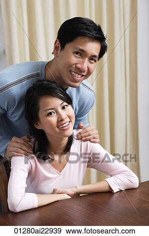 Young couple smiling at camera View Large Photo Image Stock Photo - Young couple smiling at camera. Fotosearch