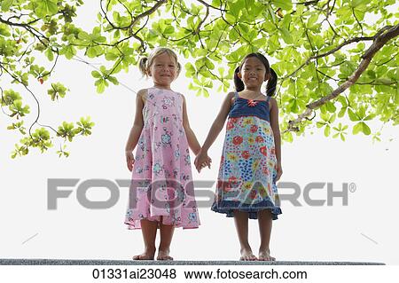 Stock Photo - Young girls holding hands. Fotosearch