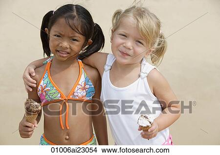 Picture - Young girls putting arms around each other. Fotosearch