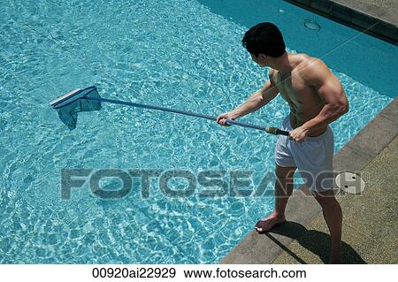 Stock Photo - Young man cleaning swimming pool. Fotosearch