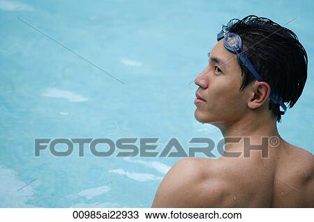 Stock Image - Young man in swimming pool. Fotosearch