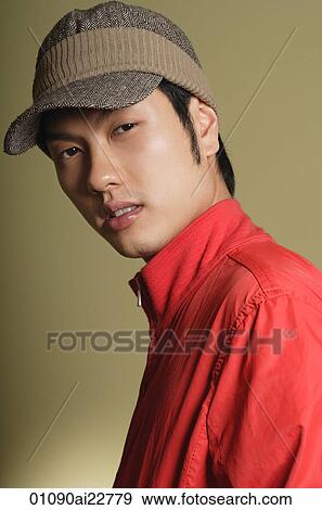 Stock Photo - Young man looking at camera. Fotosearch