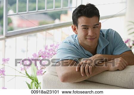 Stock Image - Young man smiling at camera. Fotosearch