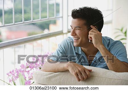 Young man talking on the phone View Large Photo Image Stock Image - Young man talking on the phone. Fotosearch