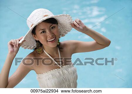 Picture - Young woman by the pool. Fotosearch