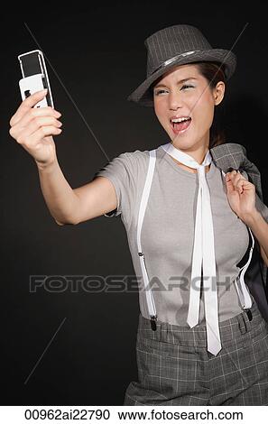 Young woman in suit outfit taking picture with mobile phone View Large Photo Image Stock Image - Young woman in suit outfit taking picture with mobile phone. Fotosearch